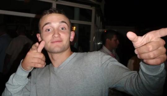 Man gesturing with both hands.