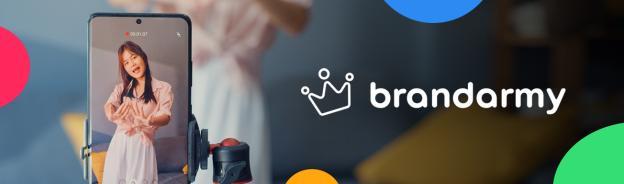 Brandarmy logo with a woman video blogging on a smartphone.