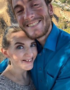 Photo of a smiling couple embracing.