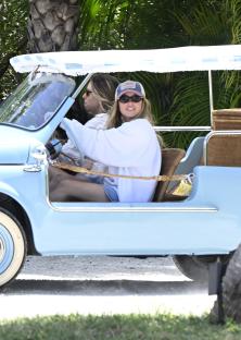 Sydney Sweeney and Jonathan Davino in a light blue car.