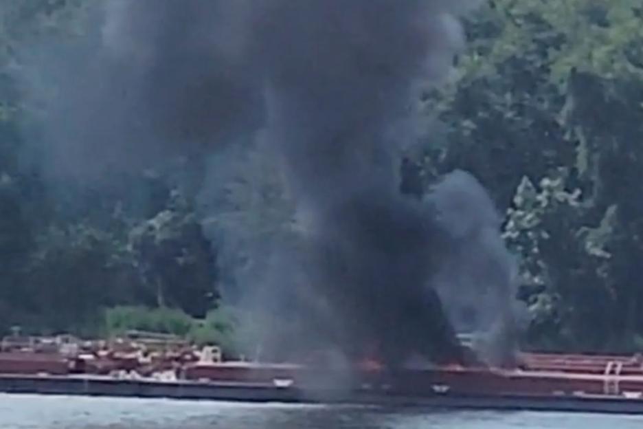 Helicopter crashes into barge killing two after hitting powerlines as burned-out wreck left on boat