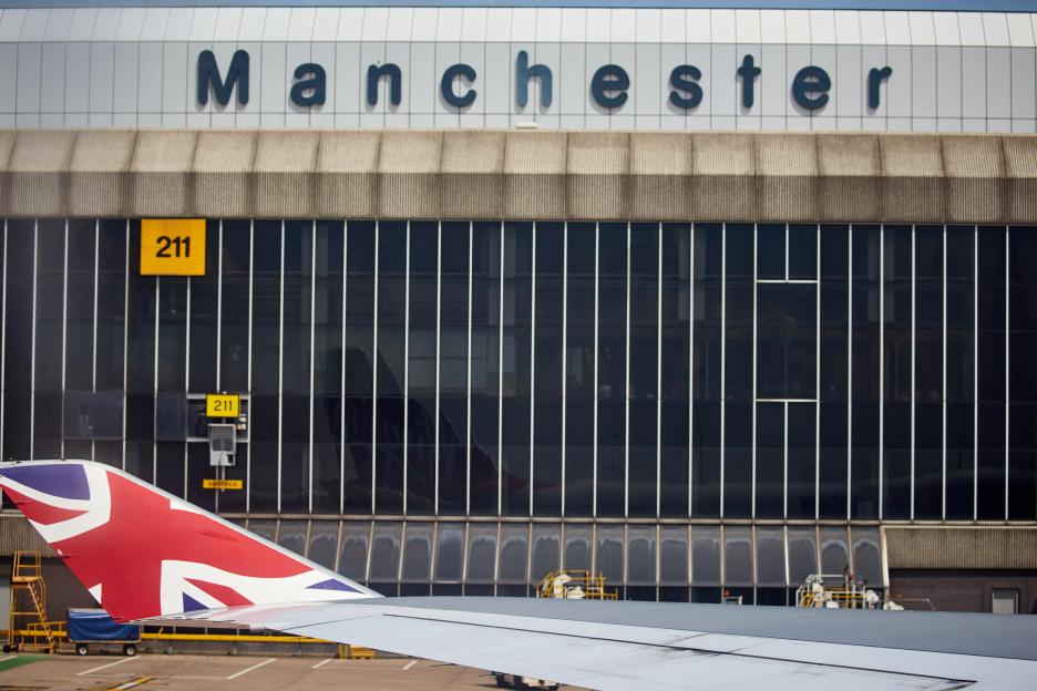 Manchester Airport terminal with a Union Jack tailfin in the foreground.