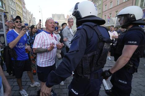 Riot police confronting Chelsea soccer fans.