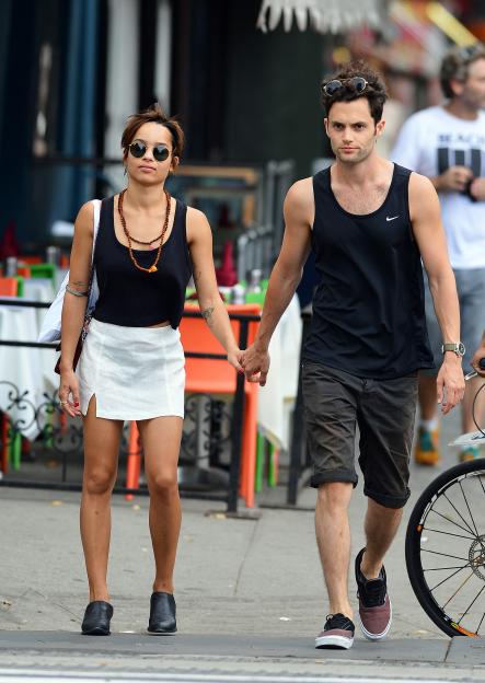 Zoe Kravitz and Penn Badgley holding hands while walking in New York City.