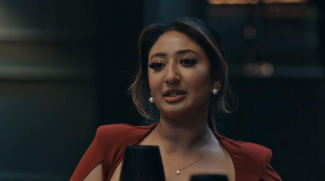 Nelly, a MAFS bride, looks tearful at a dinner party.