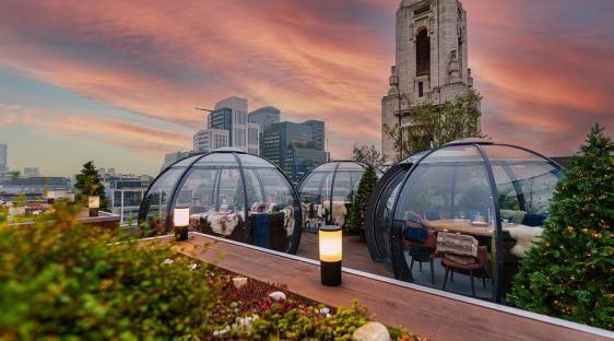Aviary Rooftop Bar & Restaurant in London with igloo dining at sunset.