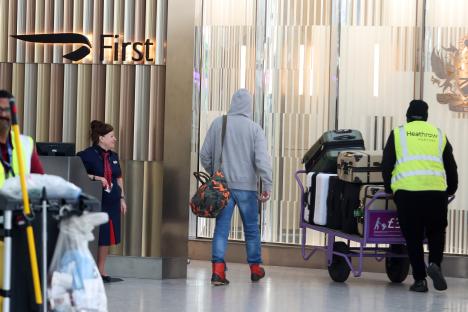 Mickey Rourke leaving a London hotel with luggage.