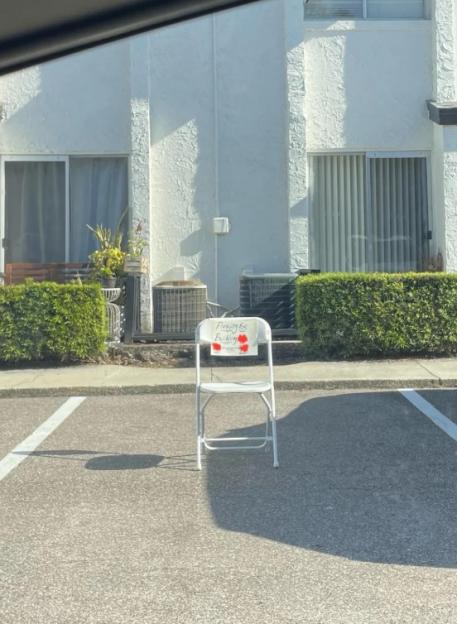 Chair reserving a parking spot.