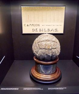 Ornate silver soccer ball on wooden base, displayed with a historical league record chart; FC Athletic Bilbao.