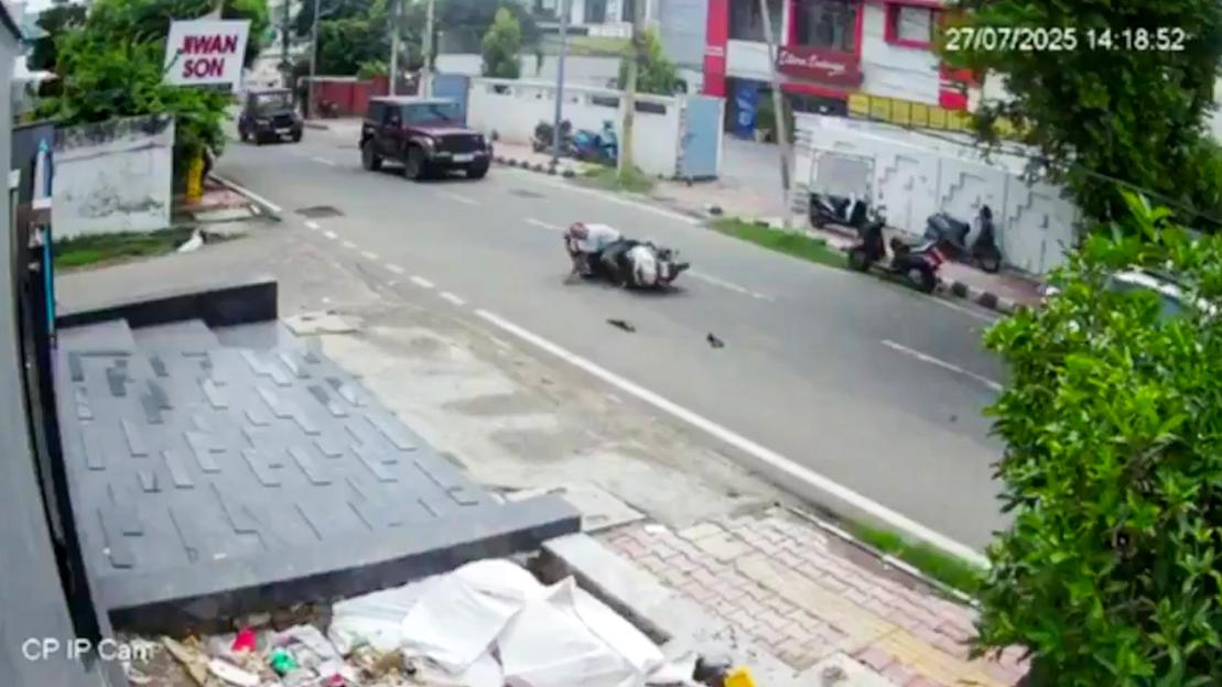 A car hitting a man on a motorcycle.