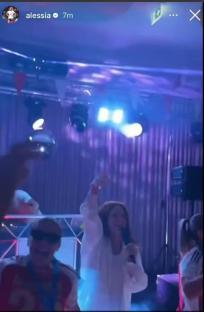 People dancing and singing at a party.