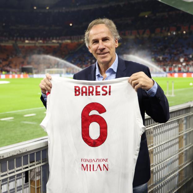 Franco Baresi holding an AC Milan jersey.