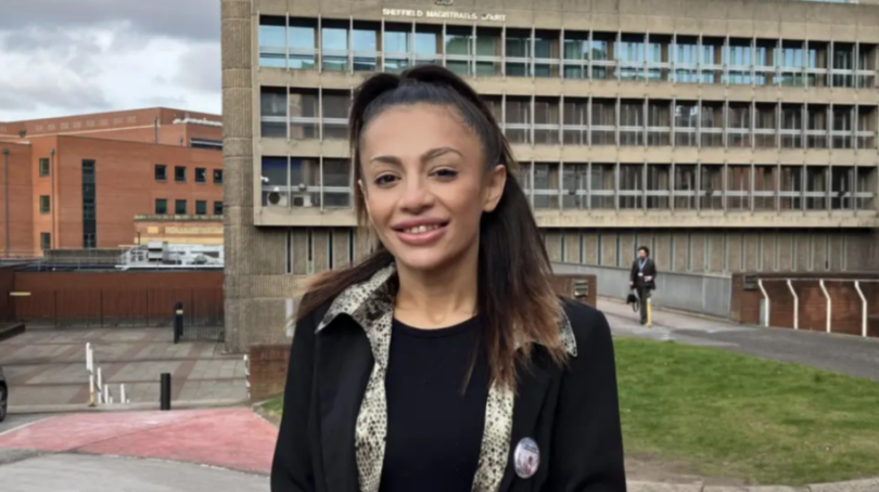 A woman smiling in front of the Sheffield Magistrates' Court.