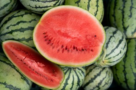 Watermelon slices and whole watermelons.