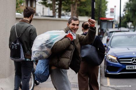 A prisoner carrying belongings is released from prison.