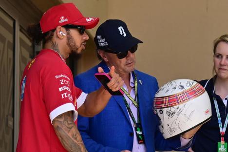 Michael Schumacher signs charity helmet with help from wife Corinna in one of his only public acts since ski crash