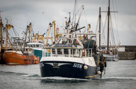 Fishing trawler entering Newlyn Harbour, Cornwall.