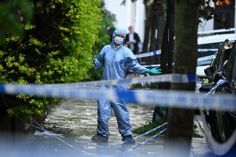 Police forensics officer at the scene of a fire investigation.