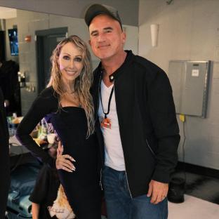 Tish Cyrus and Dominic Purcell posing for a photo.