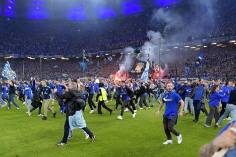 At least 25 rushed to hospital after fans storm pitch in huge invasion as club wins promotion to Germany’s Bundesliga