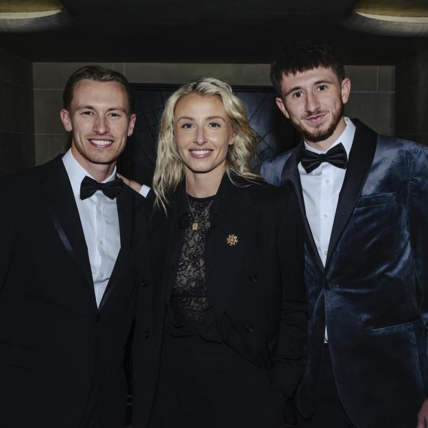 Lionesses captain Leah Williamson and two men smiling at the camera.