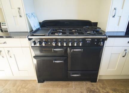 Black Rangemaster stove in a kitchen.