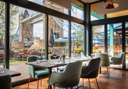 Restaurant interior with Tower Bridge view.