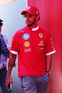 Lewis Hamilton in a red Ferrari shirt and cap.