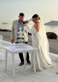Bride and groom pouring champagne into a champagne tower.