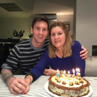 Lionel Messi with his mother and a birthday cake.