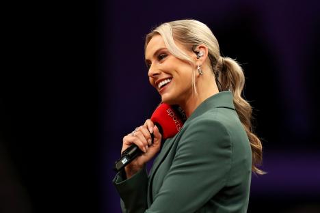 Emma Paton, Sky Sports presenter, holding a microphone.