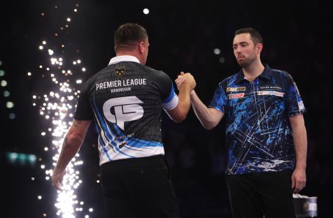 Luke Humphries congratulates Gerwyn Price after a darts match.