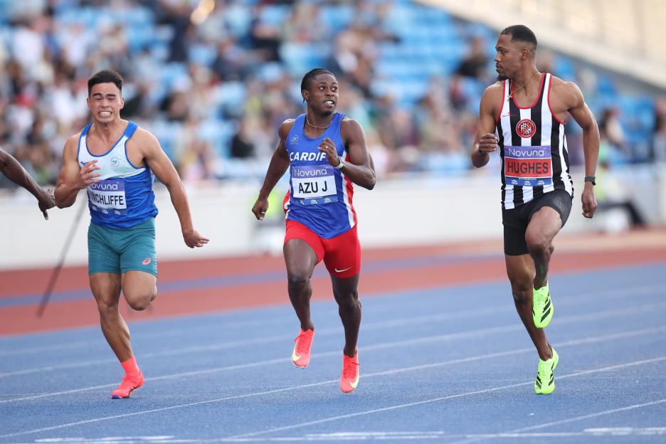 Three runners sprinting in a race.