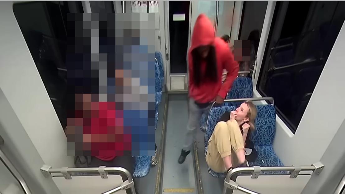 Surveillance image of a stabbing on a public transit vehicle.