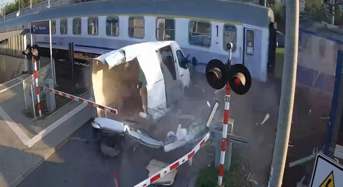 Train colliding with van at a railroad crossing.