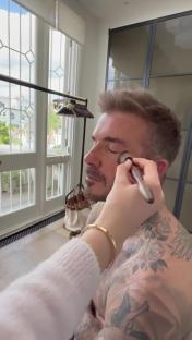David Beckham having his makeup applied.