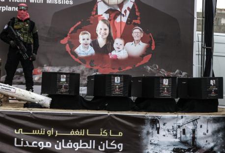 Photo of a Hamas display showing caskets of Israeli victims, a banner depicting Netanyahu as Dracula, and a soldier.