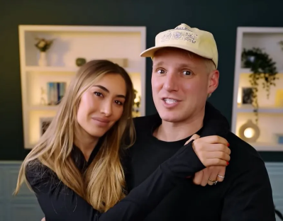 Couple embracing and smiling at the camera.