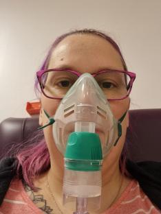 Woman using a nebulizer mask.