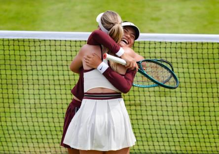 Katie Boulter and Emma Raducanu celebrating a tennis match victory.