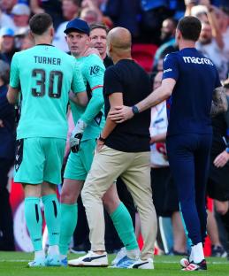 Pep Guardiola and Dean Henderson arguing after a soccer match.
