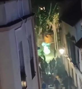 Real Betis and Fiorentina fans clashing in a street.