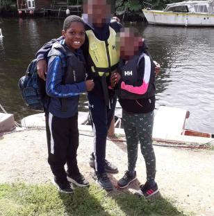 Photo of a smiling 14-year-old boy with two friends.
