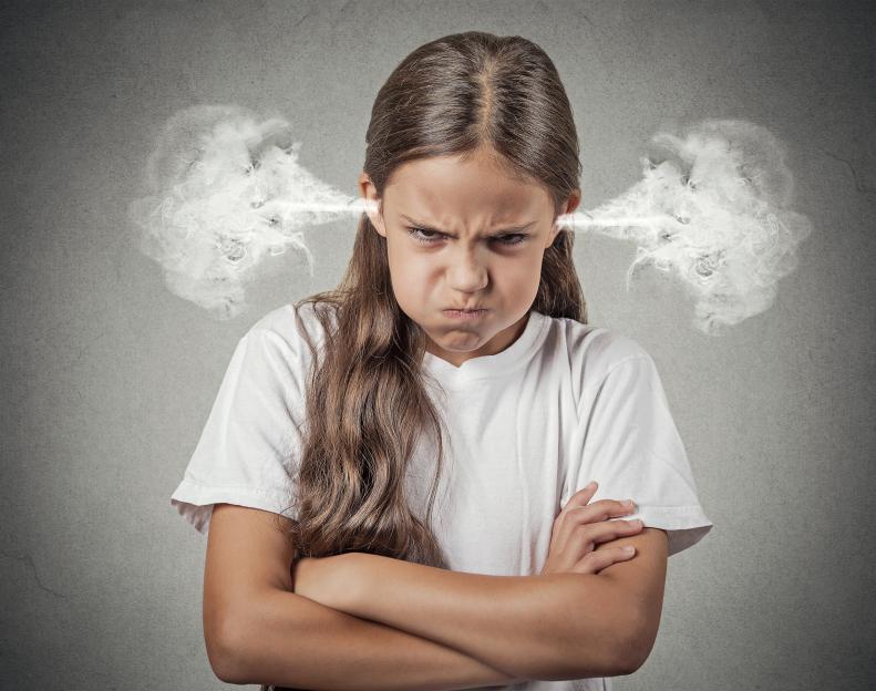 Closeup portrait of an angry young girl with steam coming out of her ears, about to have a nervous breakdown, isolated on a grey background. Negative human emotions and facial expressions.