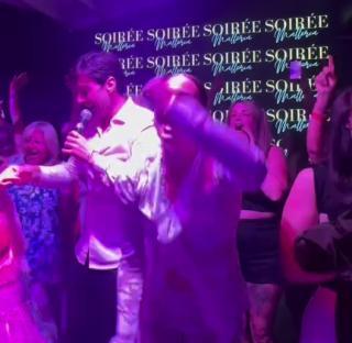 James Argent singing and dancing in a nightclub.
