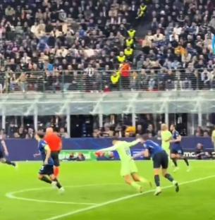 Barcelona soccer player being fouled during a game.