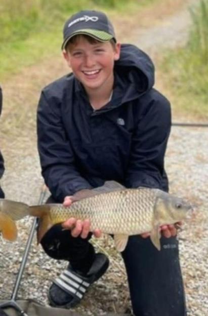 Photo of Josh Atkins holding a fish.