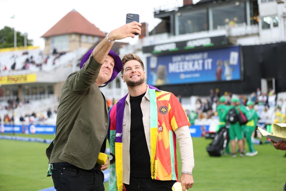 Michael Vaughan and Chris Hughes taking a selfie at a cricket match.
