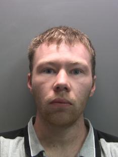Mugshot of a man with light brown hair and a light beard.