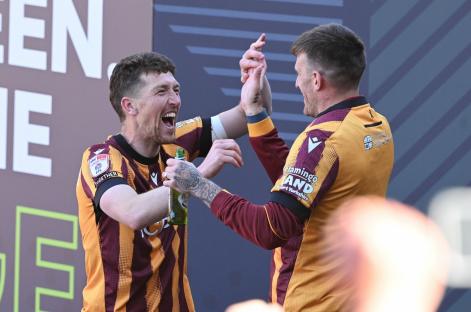 Two Bradford City players celebrating a promotion.